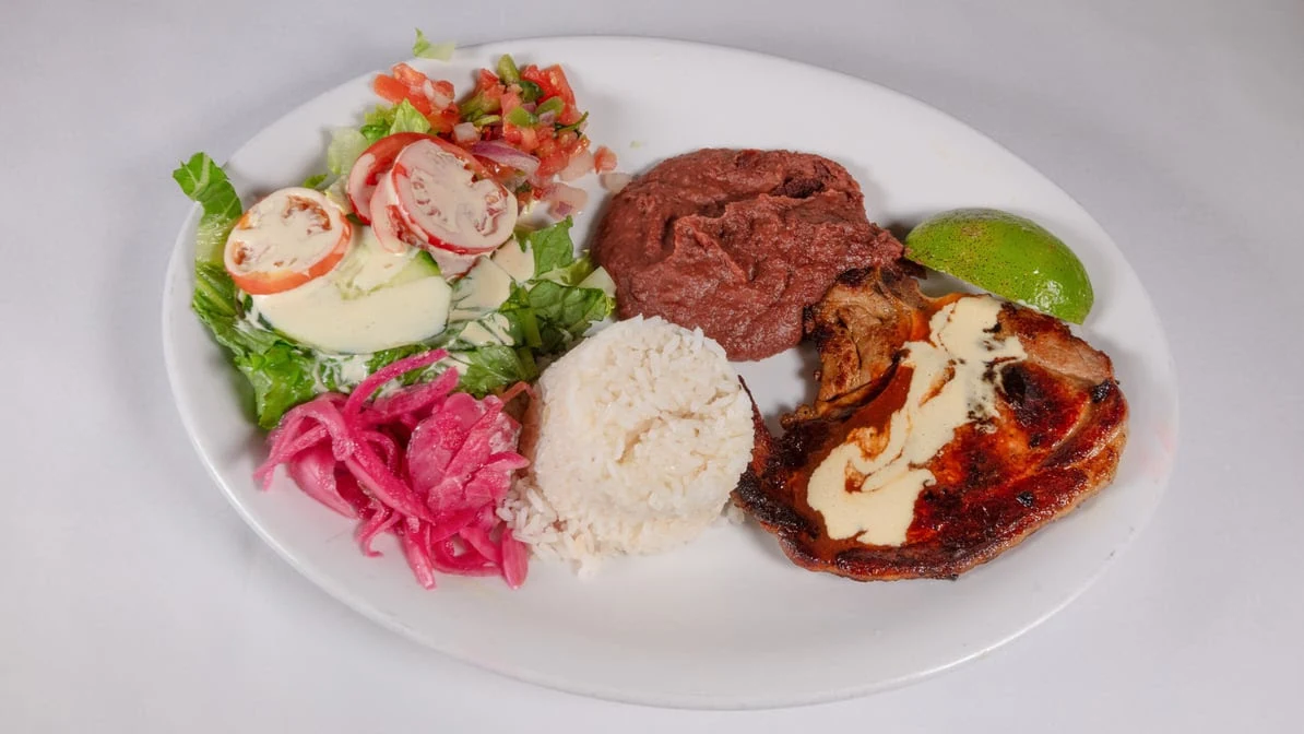 Chuleta Asada - Grilled pork chop, seasoned and charred to perfection